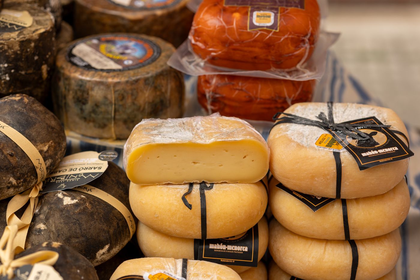 Pressed Spanish cheeses in a shop fridge