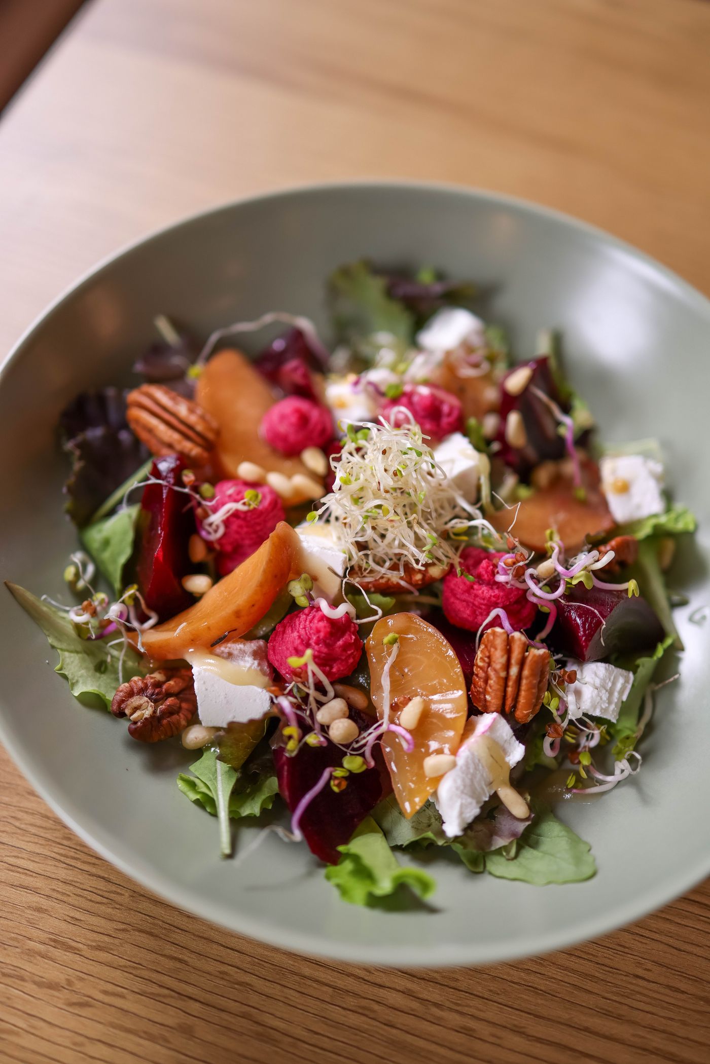Goat cheese crumbled over beet salad and nuts