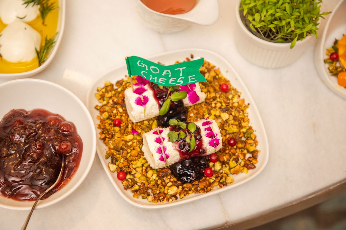 Goat cheese logs on a plate with berries