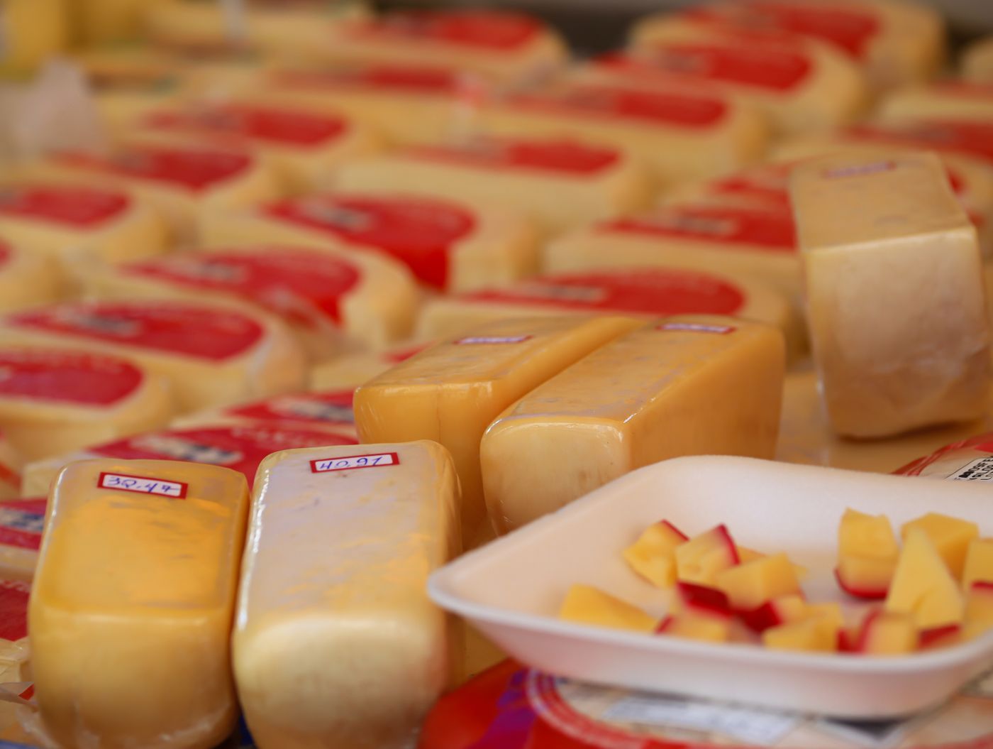 Red-waxed Edam-style wheels cut for tasting