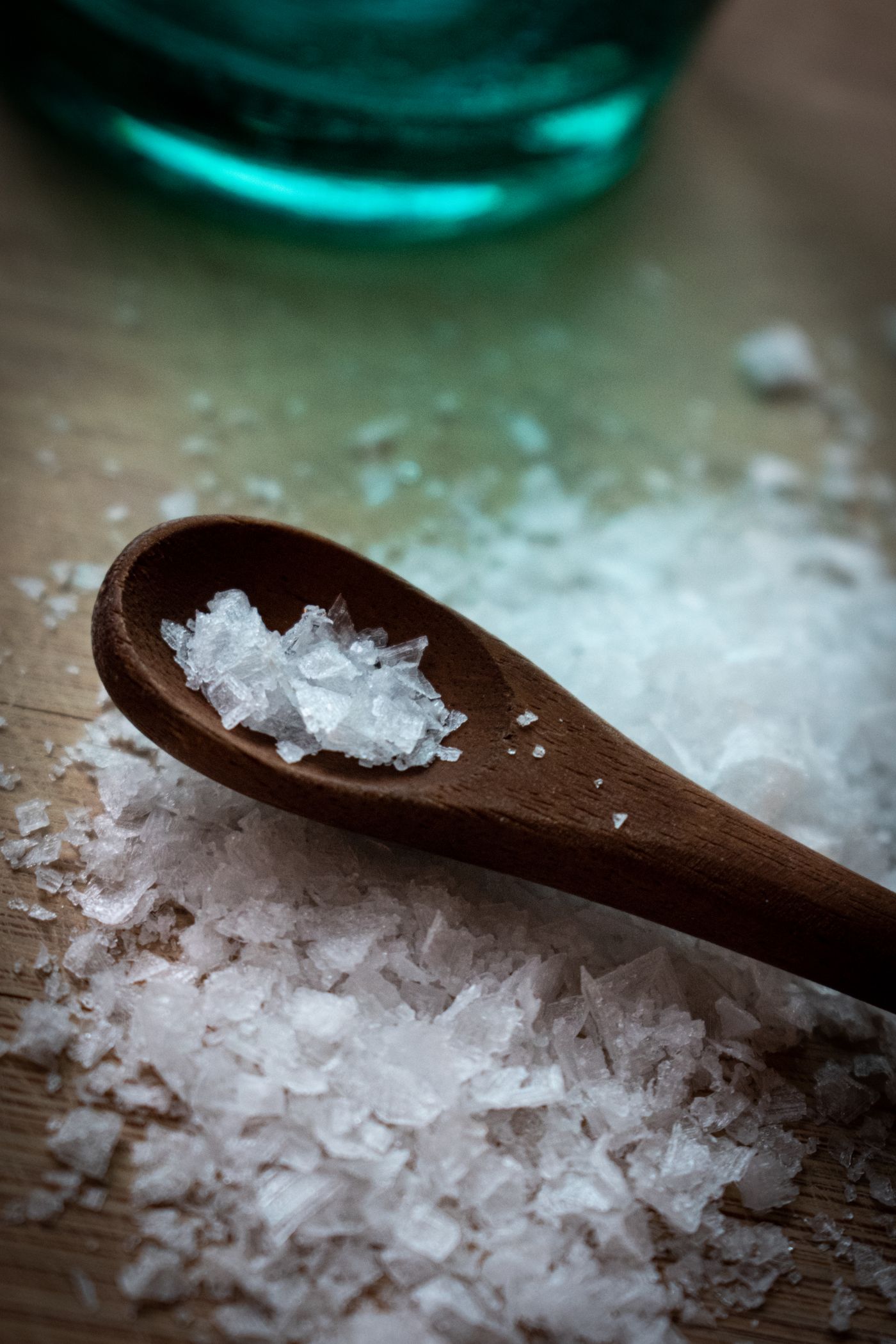Coarse salt crystals on a wooden spoon